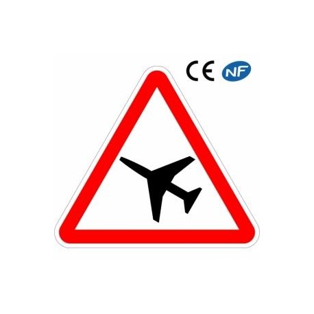 Panneau de route indiquant la traversée d'une aire de danger aérien (A23)